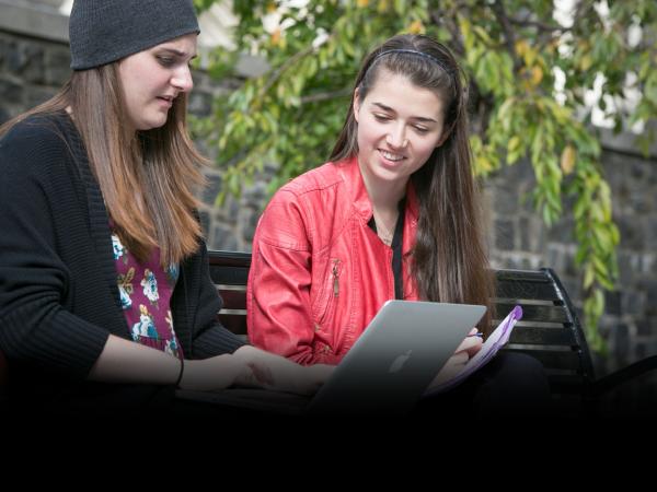 CCNY Students on campus doing research on their laptop 