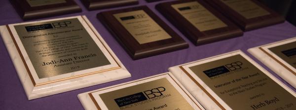 Awards laid out on the table. the table is a purple color 