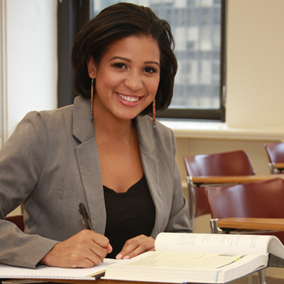 CCNY Student in classroom smiling 