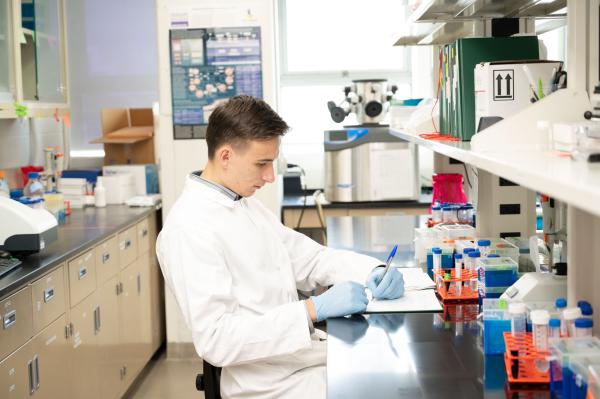 CInC - Researcher taking notes in lab