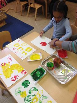 Children working on an art project with hand prints