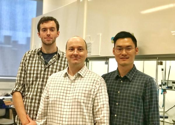 Ph.D. candidates Benjamin Murray, left, and Shibin Zhao, right, flank CCNY chemistry professor Mark Biscoe.