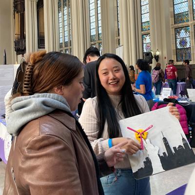 Two students looking at each other during a club fair